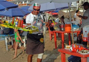 Johnny selling oysters on the beach in PV