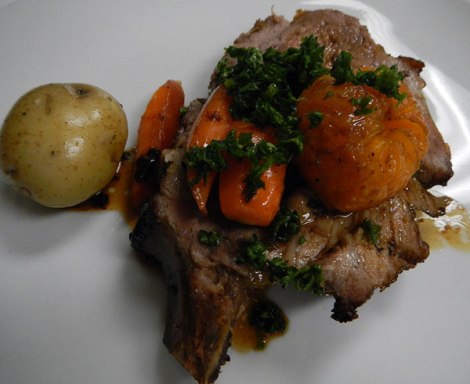 Roasted pork rack with mandarins, potatoes and carrots