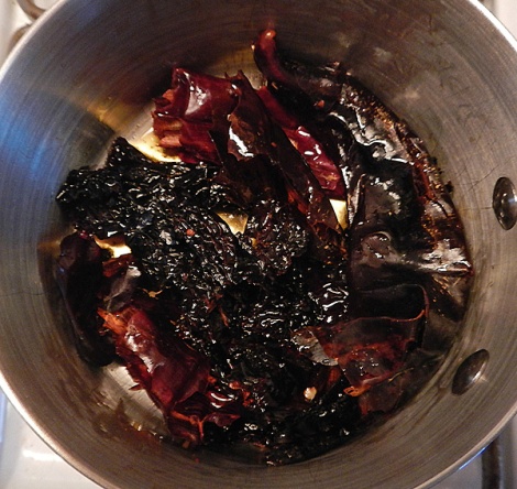 fry guajillo and mulato chiles in hot oil, being careful not to burn