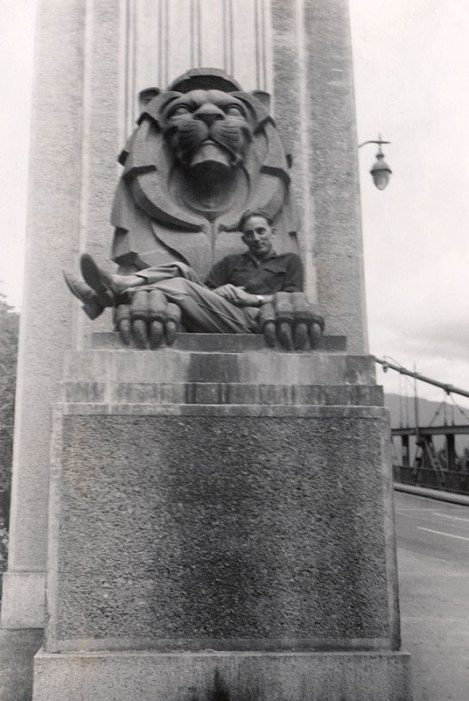 dad being an imp and climbing up on one of the Lions on the Bridge