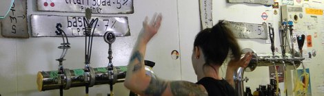 A bartender dances while she waits for a growler to fill at Storm Brewing in Vancouver